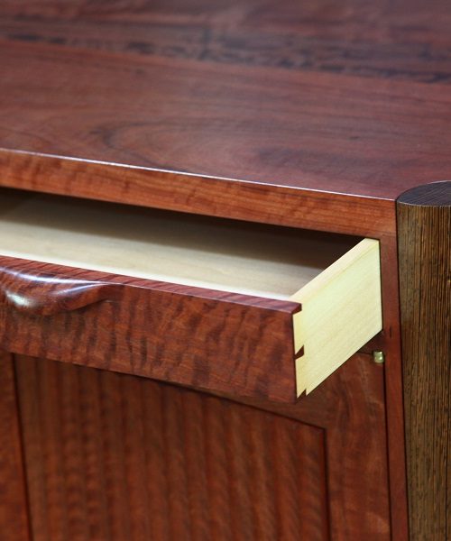 A traditionally made drawer in a red gum cabinet.