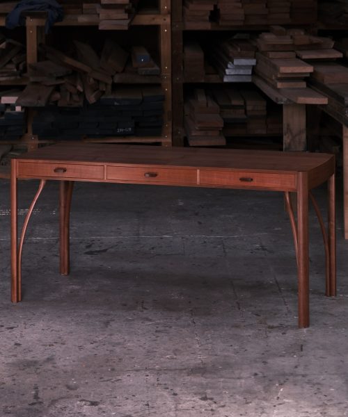 A beautiful Tasmanian myrtle and gidgee desk photographed in an Australian woodworking workshop.