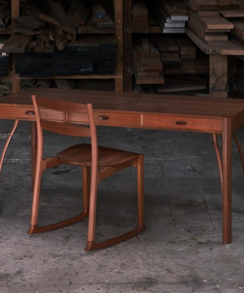 A beautiful Tasmanian myrtle and gidgee desk photographed in an Australian woodworking workshop.
