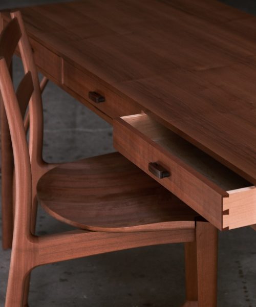A beautiful Tasmanian myrtle and gidgee desk photographed in an Australian woodworking workshop.